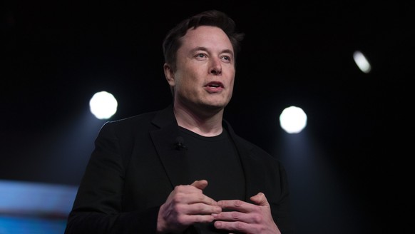 FILE - In this March 14, 2019, file photo, Tesla CEO Elon Musk speaks before unveiling the Model Y at the company&#039;s design studio in Hawthorne, Calif. Musk is asking on Twitter whether he should  ...