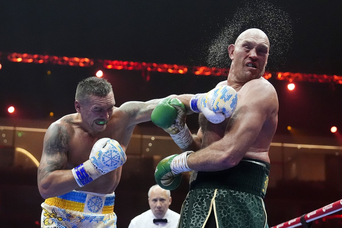 Britain?s Tyson Fury, right, takes a blow from Ukraine?s Oleksandr Usyk during their undisputed heavyweight world championship boxing fight at the Kingdom Arena in Riyadh, Saudi Arabia, Sunday, May 19 ...