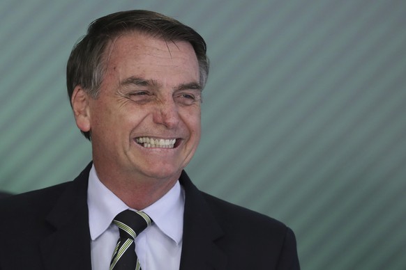 Brazil&#039;s President Jair Bolsonaro smiles during a ceremony where he signed a decree loosening restrictions on owning a firearm at Planalto presidential palace in Brasilia, Brazil, Tuesday, Jan. 1 ...