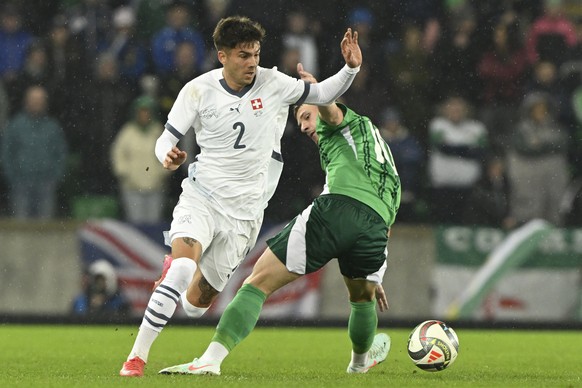 Switzerland&#039;s Lucas Blondel, left, and Northern Ireland&#039;s Jamie Donley in action during an international test match between Northern Ireland and Switzerland, at Windsor Park stadium in Belfa ...