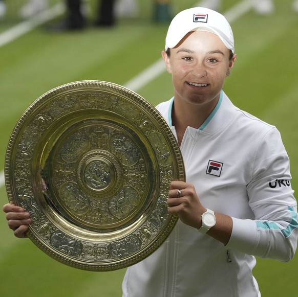 Australia&#039;s Ashleigh Barty holds the trophy after winning the women&#039;s singles final match against Czech Republic&#039;s Karolina Pliskova on day twelve of the Wimbledon Tennis Championships  ...