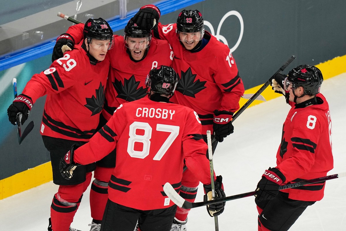 Canada's Connor McDavid celebrates with teammates after scoring his sides first goal during a preliminary round match of men's ice hockey between Canada and Switzerland at the 2026 Winter Ol ...