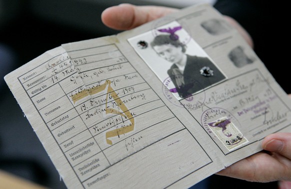 Historian Beate Kosmala from the Memorial to the German Resistance holds an identification card used during the Third Reich in Berlin, April 17, 2007. More than 60 years after the Holocaust, Germany i ...