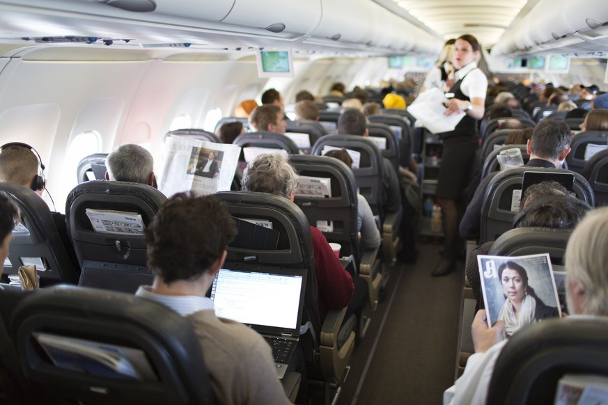 A flight attendant serves breakfast during the flight to Zurich, pictured on April 12, 2013, in an Airbus A319. The Airbus A319, an aircraft of Swiss International Air Lines, flies from Zurich to Oslo ...