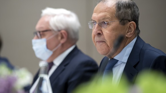 Russian Foreign Minister Sergey Lavrov, rights, and Russian Deputy Foreign Minister Sergei Ryabkov, left, listens during a meeting on soaring tensions over Ukraine in Geneva, Switzerland, Friday, Janu ...