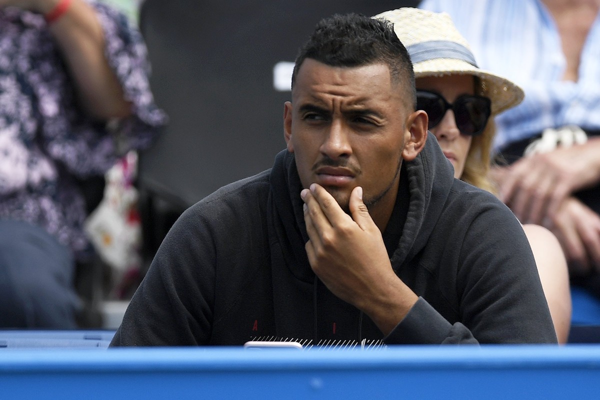 epa06039064 Australia's Nick Kyrgios watches Canada's Milos Raonic playing against Thanasi Kokkinaki of Australia during an Aegon tennis championships match at the Queens Club in London, Bri ...