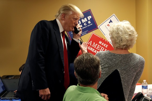 Republican presidential nominee Donald Trump talks on the phone during a visit to a Trump campaign call center in Asheville, North Carolina, U.S., September 12, 2016. REUTERS/Mike Segar