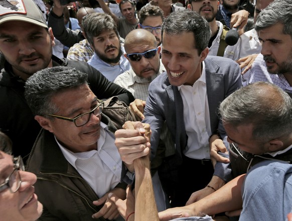 Venezuela&#039;s self-declared interim leader Juan Guaido, center, greets supporters after a rally at a public plaza in Las Mercedes neighborhood of Caracas, Venezuela, Saturday, Jan. 29, 2019. Venezu ...