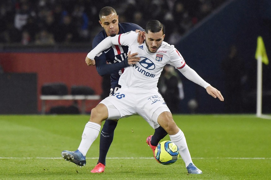 epa08206442 Lyon's Ryan Cherki (R) and Paris Saint Germain's Layvin Kurzawa (L) in action during the French Ligue 1 soccer match between PSG and Lyon at the Parc des Princes stadium in Paris ...