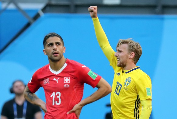 epa06861215 Emil Forsberg of Sweden (R) reacts after scoring the 1-0 as Ricardo Rodriguez of Switzerland looks dejected during the FIFA World Cup 2018 round of 16 soccer match between Sweden and Switz ...