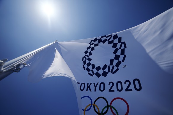 A Tokyo 2020 Olympic flag flies over the top of the bleachers at Ariake Tennis Center, Monday, July 19, 2021, in Tokyo. (AP Photo/Kiichiro Sato)