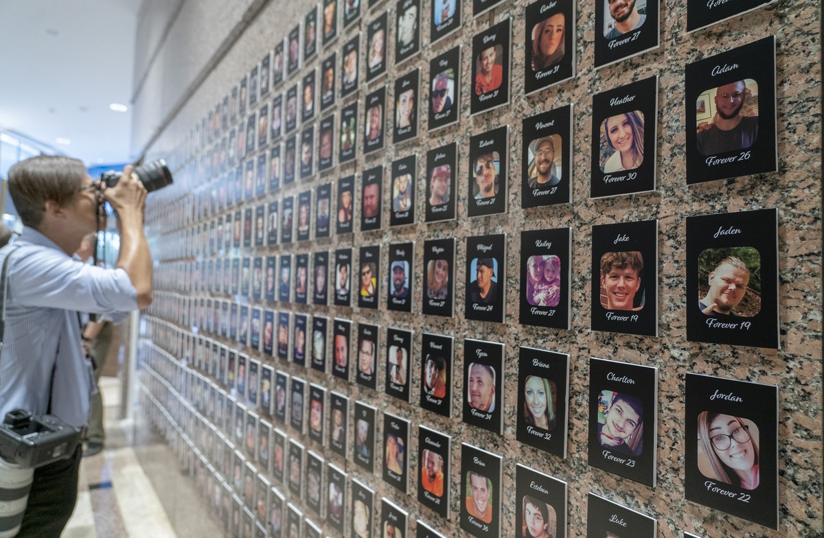 FILE�??A photojournalist takes pictures of the exhibits on "The Faces of Fentanyl" at DEA headquarters before a press event at DEA headquarters, Arlington, Va., in this file photo from Sept. ...