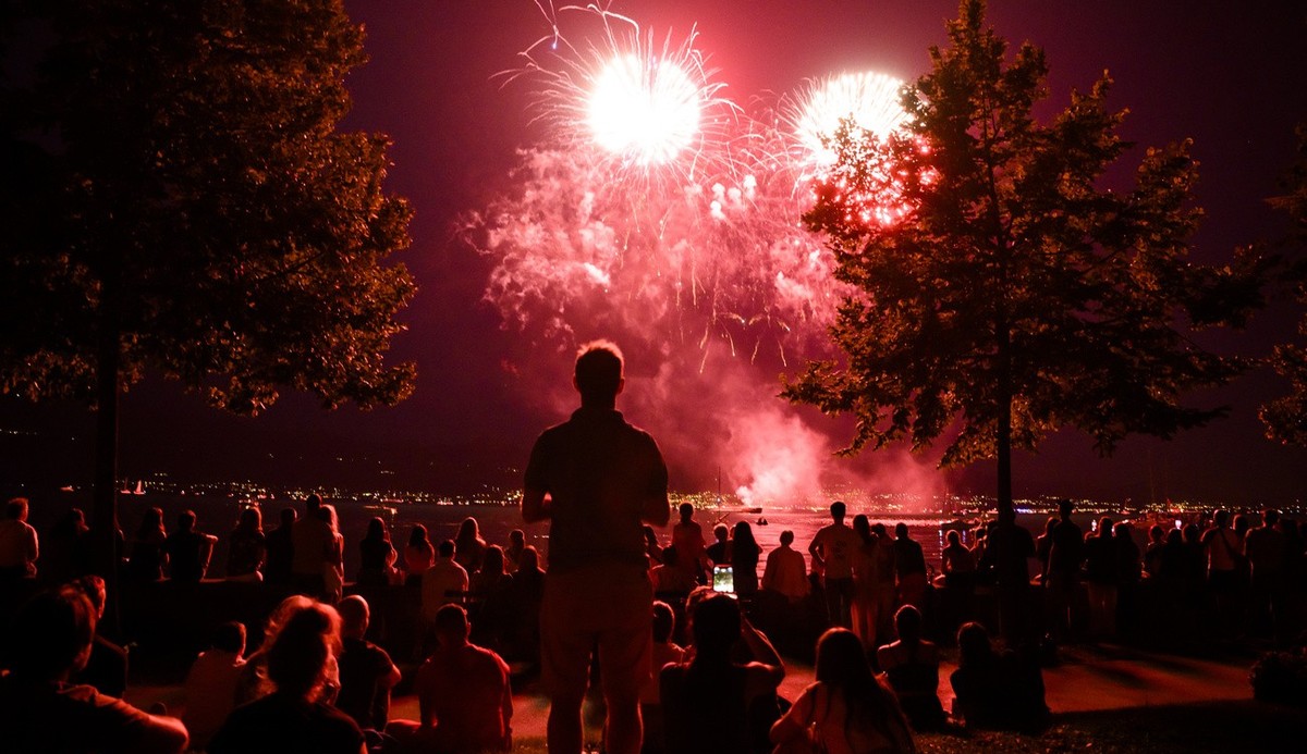 La population regarde le traditionnel feu d'artifice au bord du lac Leman a Ouchy lors de la Fete nationale le lundi 1 aout 2022 a Lausanne. (KEYSTONE/Jean-Christophe Bott)