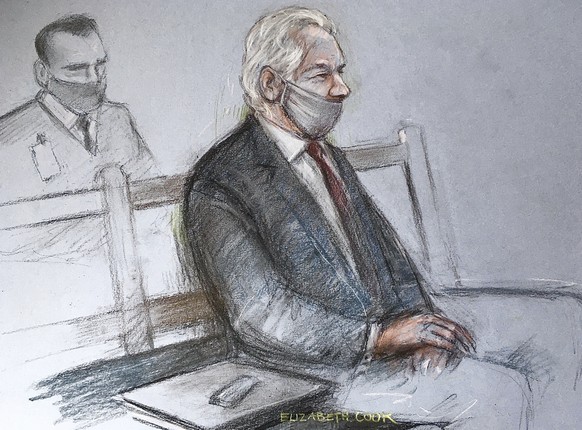 This is a court artist sketch by Elizabeth Cook of Julian Assange appearing at the Old Bailey in London for the ruling in his extradition case, in London, Monday, Jan. 4, 2021. A British judge has rej ...