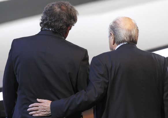 FILE - In this June 1, 2011 file photo Swiss FIFA President Joseph Blatter, right, and French UEFA President Michel Platini walk together at the 61st FIFA Congress in Zurich, Switzerland. On Thursday, ...