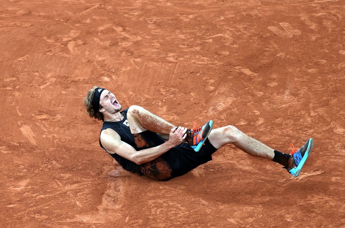 epa09994179 Alexander Zverev of Germany is injured on the court after falling in the men's semi-final match against Rafael Nadal of Spain during the French Open tennis tournament at Roland ​Garro ...