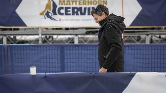 Franz Julen, president of the organizing committee, leaves the finish area after the women's downhill race on the new ski course "Gran Becca" was cancelled due to strong winds, at the A ...