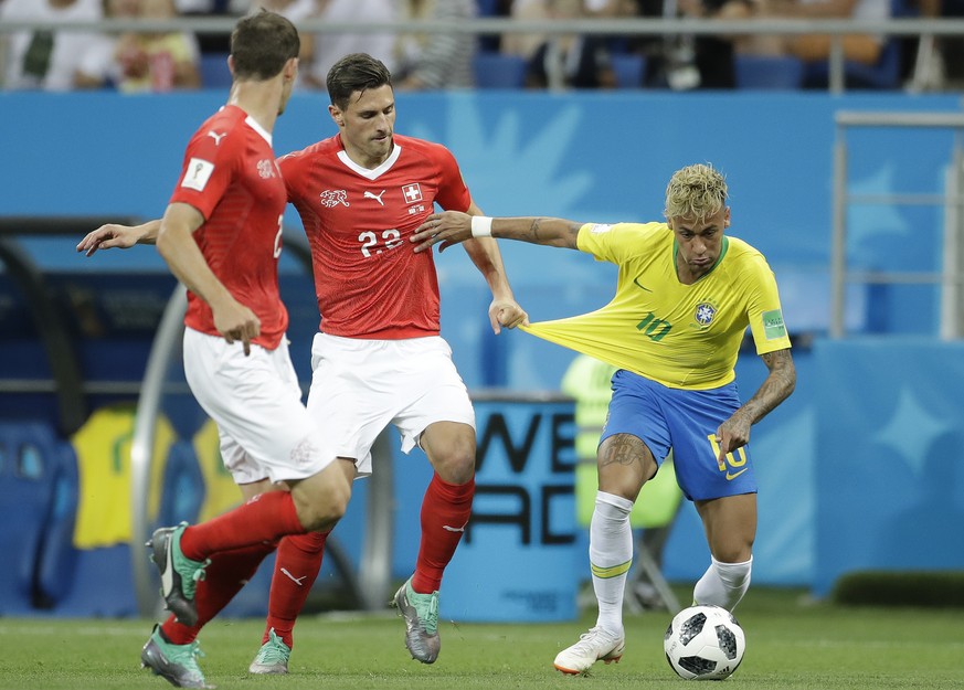 Switzerland's Fabian Schaer, center, stops Brazil's Neymar during the group E match between Brazil and Switzerland at the 2018 soccer World Cup in the Rostov Arena in Rostov-on-Don, Russia, ...