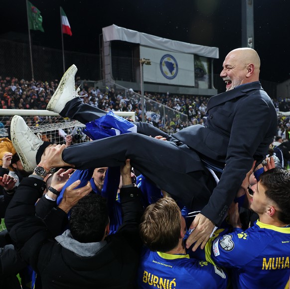 Bosnia's coach Sergej Barbarez is chaired aloft as he celebrates after winning a penalty shootout during the World Cup qualifying playoff final soccer match between Bosnia and Italy in Zenica, Bo ...