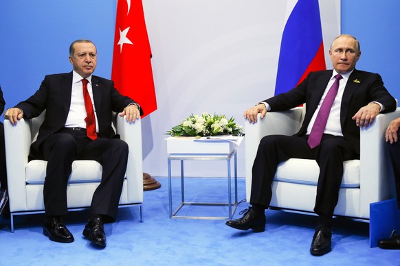 Russian President Vladimir Putin, right, and Turkish President Recep Tayyip Erdogan attend the talks at the G-20 summit in Hamburg, northern Germany, Saturday, July 8, 2017. Putin and Erdogan underlin ...