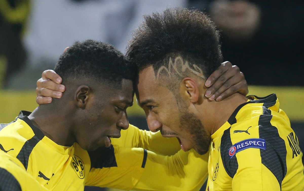 Dortmund's Ousmane Dembele, left, congratulates Dortmund's Pierre-Emerick Aubameyang as they celebrate after scoring the opening goal during the Champions League round of 16, second leg, soc ...