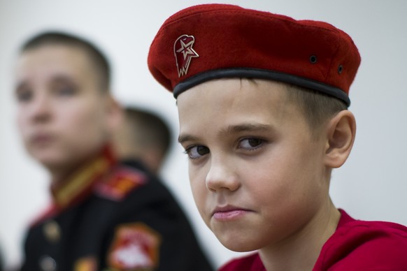 In this photo taken on Friday, Oct. 28, 2016, Daniil Yakupov, 11, right, attends a meeting at a Russian military recruiting center in Yekaterinburg, Russia. Yunarmia (Young Army) is an organization sp ...