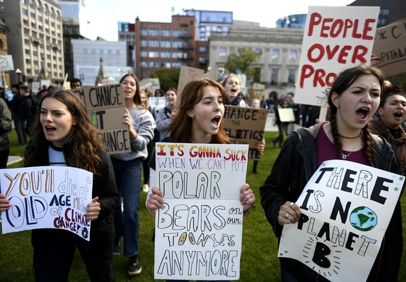 People arriving on Parliament Hill chant as they participate in a Global Climate Strike organized by Fridays for Future,in Ottawa, Ontario, Friday, Sept. 23, 2022. (Justin Tang/The Canadian Press via  ...