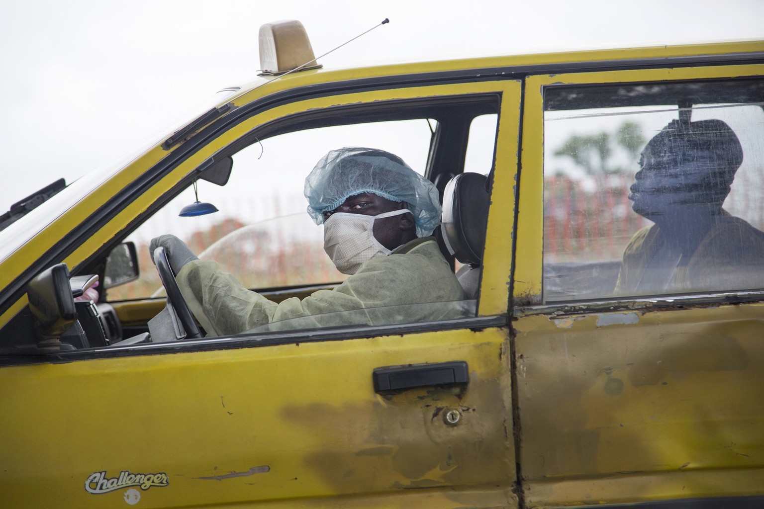 On 3 September in Liberia, a taxi driver – wearing a surgical cap, mask, gloves and robe – transports a sick woman to an Ebola treatment clinic in Monrovia, the capital.

The worst outbreak of Ebola v ...