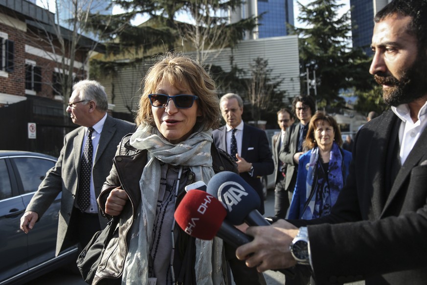 United Nations Special Rapporteur Agnes Callamard, surrounded by members of the media walks around the Saudi Consulate, background, in Istanbul, Tuesday, Jan. 29, 2019. Callamard and her team of exper ...