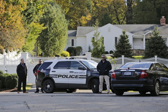 Police officers stand in front of property owned by Hillary and Bill Clinton in Chappaqua, N.Y., Wednesday, Oct. 24, 2018. A U.S. official says a &quot;functional explosive device&quot; was found at t ...