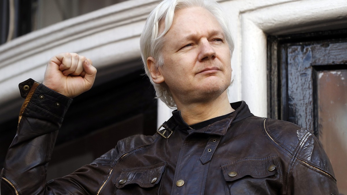FILE - Julian Assange greets supporters outside the Ecuadorian embassy in London, May 19, 2017. (AP Photo/Frank Augstein, File)