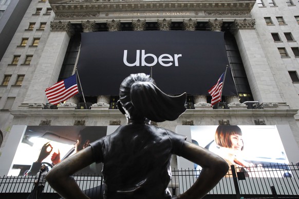 FILE - In this May 10, 2019, file photo the statue of Fearless Girl stands in front of the New York Stock Exchange before Uber, the world&#039;s largest ride-hailing service, holds its initial public  ...
