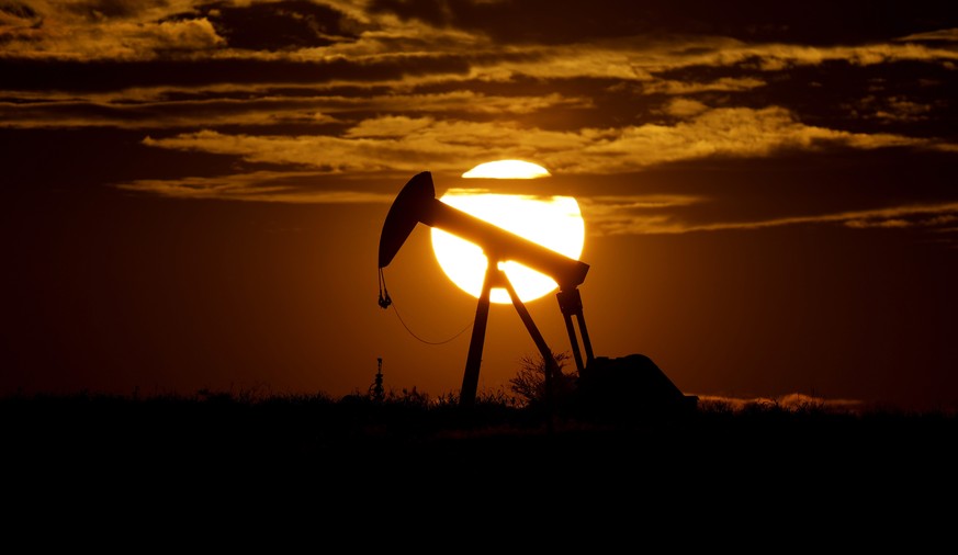 FILE - In this Wednesday, April 8, 2020 file photo, the sun sets behind an idle pump jack near Karnes City, USA. The OPEC oil cartel and allied countries are meeting to decide on production. The meeti ...