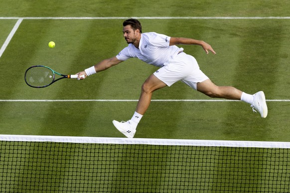 epa10037306 Stan Wawrinka of Switzerland in action during his men&#039;s first round match against Jannik Sinner of Italy at the Wimbledon Championships in Wimbledon, Britain, 27 June 2022. EPA/PETER  ...