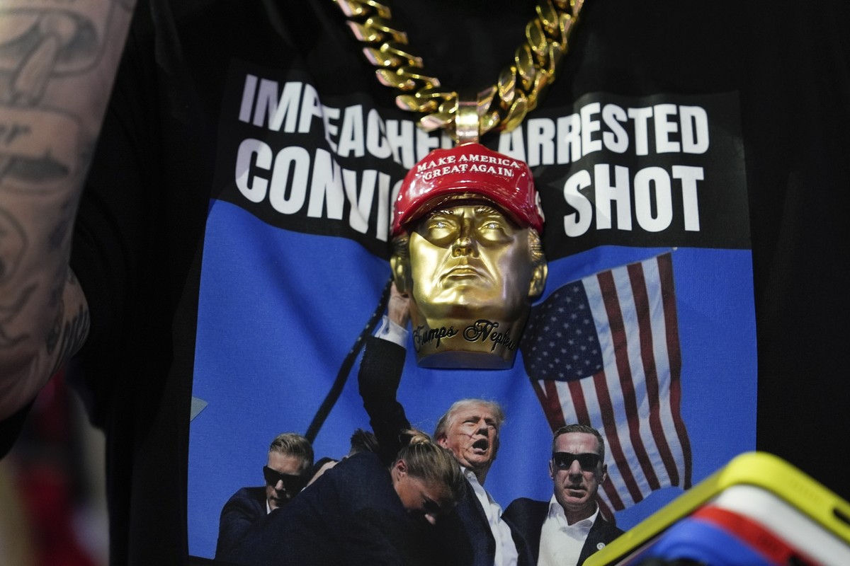 A delegate wears a tee shirt with a photo of Republican presidential candidate former President Donald Trump being surrounded by U.S. Secret Service agents at a campaign rally during the Republican Na ...