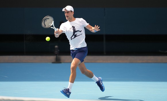 epa09678312 A handout photo made available by Tennis Australia of Novak Djokovic of Serbia during a practice session ahead of the Australian Open, Melbourne Park, in Melbourne, Australia 11 January 20 ...