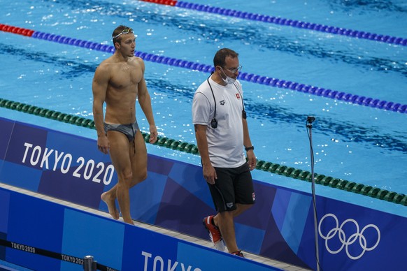 epa09359021 Antonio Djakovic of Switzerland and his coach Paul Kutscher (R) are pictured during a training session prior to the start of the Swimming events of the Tokyo 2020 Olympic Games at the Toky ...