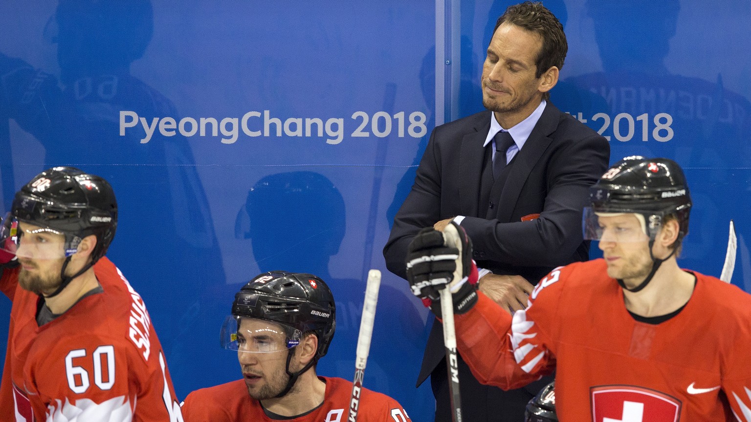Tristan Scherwey of Switzerland, Simon Moser of Switzerland, Patrick Fischer, head coach of Switzerland, and Simon Bodenmann of Switzerland, from left, react after the men ice hockey play-off qualific ...