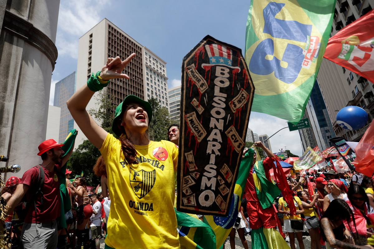 A demonstrator carries a coffin-shaped sign symbolizing the death of Bolsonarism and depicting opposition presidential candidate Sen. Flavio Bolsonaro during a student rally in support of Brazilian Pr ...
