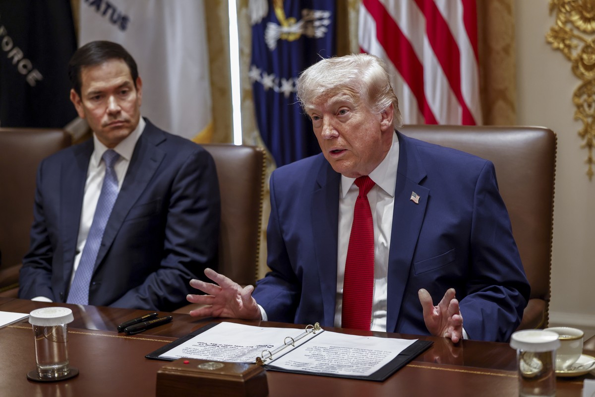 epa12851180 US Secretary of State Marco Rubio (L) looks on as US President Donald J. Trump delivers remarks during a Cabinet meeting in the Cabinet Room of the White House in Washington, DC, USA, 26 M ...
