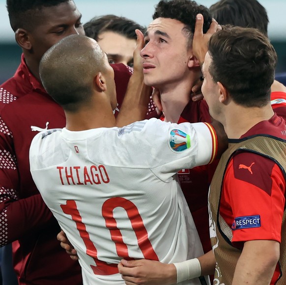epa09318802 SPanish Thiago Alcantara (L) comforts Ruben Vargas (R) after Switzerland losing the UEFA EURO 2020 quarter final match between Switzerland and Spain in St.Petersburg, Russia, 02 July 2021. ...