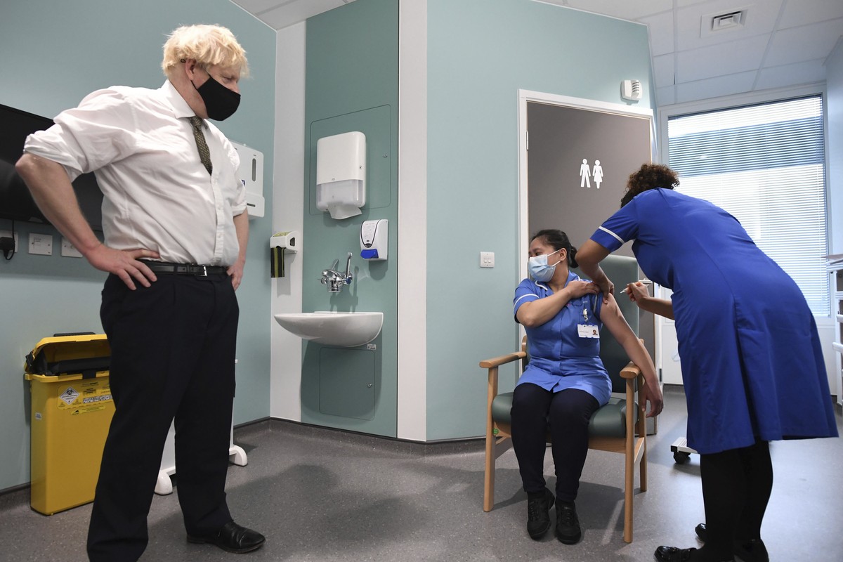 FILE - In this Jan. 4, 2021 file photo Britain's Prime Minister Boris Johnson watches as nurse Jennifer Dumasi is injected with the Oxford-AstraZeneca COVID-19 vaccine, during a visit to view the ...
