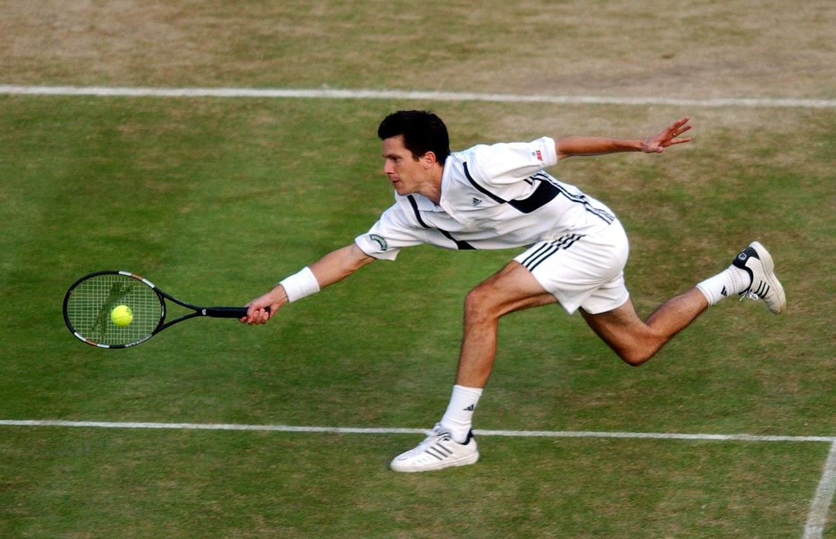 Britain's Tim Henman plays a forehand return to Mark Philippoussis of Australia during their fourth round Centre Court match at the All England Lawn Tennis Championships in Wimbledon, Monday 28 J ...