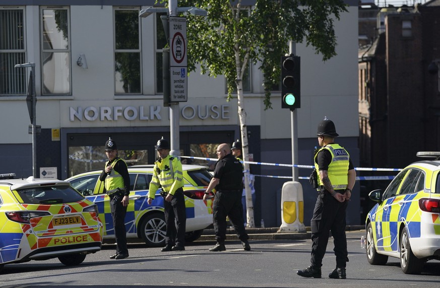 Police officers block a road in Nottingham, Britain, Tuesday, June 13, 2023. Police say the emergency services are responding to an ?ongoing serious incident? in the central England city of Nottingham ...