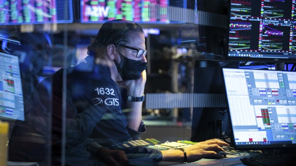 In this photo provided by the New York Stock Exchange, specialist Gregg Maloney works at his post on the trading floor, Wednesday Oct. 28, 2020. The Dow Jones Industrial Average dropped 943 points Wed ...