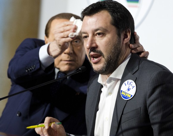 Forza Italia&#039;s Silvio Berlusconi, left, wipes the forehead of The League&#039;s Matteo Salvini at a media event for center-right leaders ahead of the March 4 general elections, in Rome, Thursday, ...