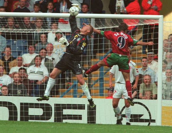 Danish goalkeeper Peter Schmeichel (L) block a ball in front of Portuguese striker Ricardo Sa Pinto (No9) during the European Soccer Championships match at Hillsborough stadium in Sheffield, June 9, 1 ...