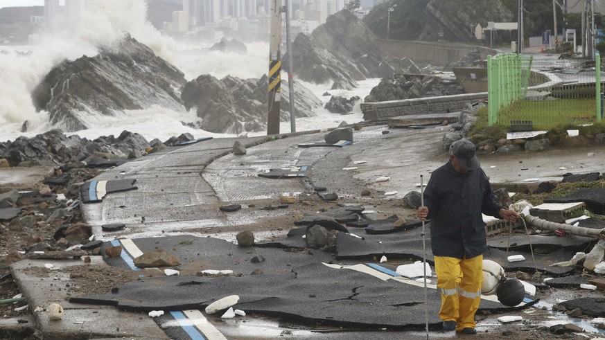 A road is damaged as waves hit a shore in Ulsan, South Korea, Tuesday, Sept. 6, 2022. The most powerful typhoon to hit South Korea in years battered its southern region Tuesday, dumping almost a meter ...