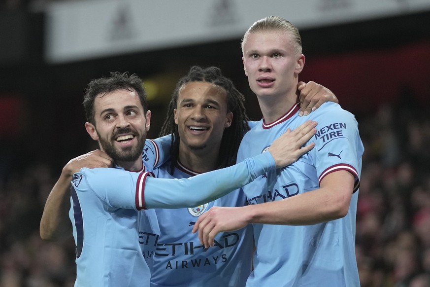 Manchester City&#039;s Erling Haaland, right, celebrates after scoring with Manchester City&#039;s Bernardo Silva, left, and Manchester City&#039;s Nathan Ake during the English Premier League soccer  ...