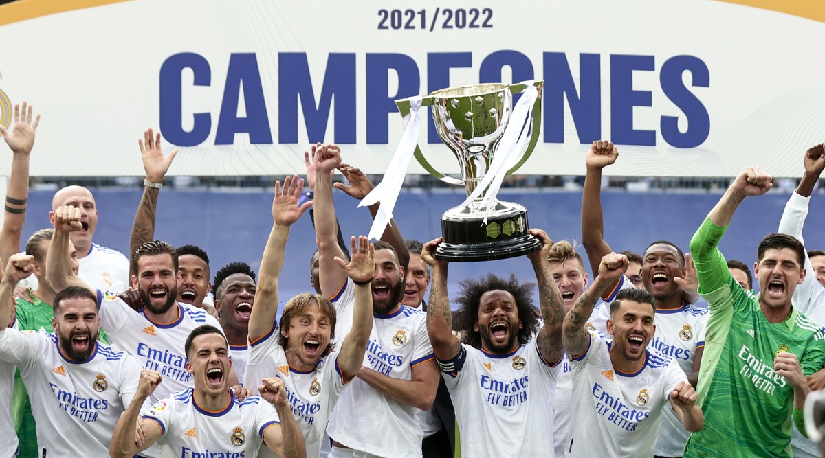 In this photo provided by the Spanish Royal Football Federation, Real Madrid player Marcelo lifts the trophy celebrating the team's La Liga title after a Spanish La Liga soccer match between Real ...